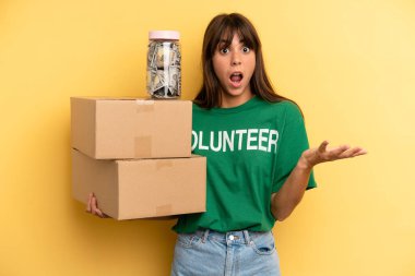 pretty woman feeling extremely shocked and surprised. volunteer and donation concept