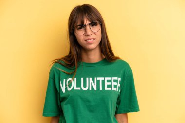 pretty woman feeling puzzled and confused. volunteer and donation concept