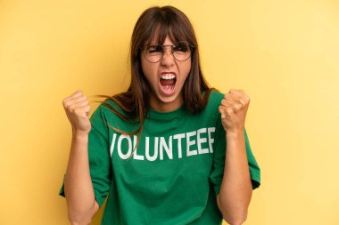 pretty woman shouting aggressively with an angry expression. volunteer and donation concept