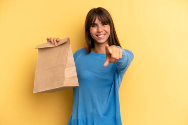 pretty woman pointing at camera choosing you. take away fast food concept