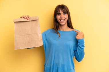 pretty woman feeling happy and pointing to self with an excited. take away fast food concept