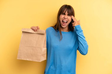 pretty woman looking unhappy and stressed, suicide gesture making gun sign. take away fast food concept