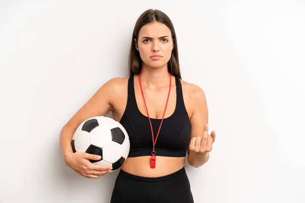 pretty girl feeling angry, annoyed, rebellious and aggressive. soccer and fitness concept
