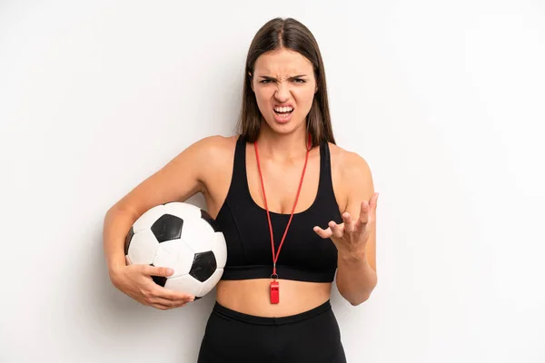 pretty girl looking angry, annoyed and frustrated. soccer and fitness concept