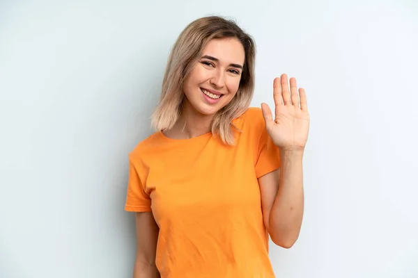 Young Adult Pretty Woman Smiling Happily Cheerfully Waving Hand Welcoming — Photo