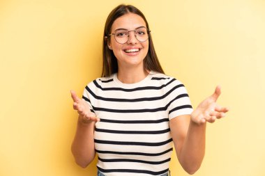 young adult pretty woman feeling happy, astonished, lucky and surprised, like saying omg seriously? Unbelievable
