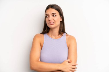 Genç ve güzel bir kadın şüpheye düşüyor ya da düşünüyor, dudağını ısırıyor ve kendini güvensiz ve gergin hissediyor, kenarda yer arıyor.