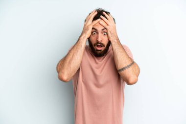 Genç, sakallı bir adam dehşete kapılmış ve şok olmuş hissediyor.