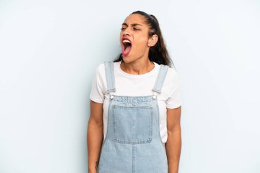 İspanyol güzel kadın öfkeyle bağırıyor, agresif bir şekilde bağırıyor, stresli ve kızgın görünüyor.