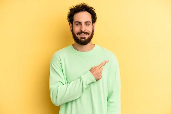 Young Adult Bearded Man Smiling Cheerfully Feeling Happy Pointing Side — Stock Photo, Image