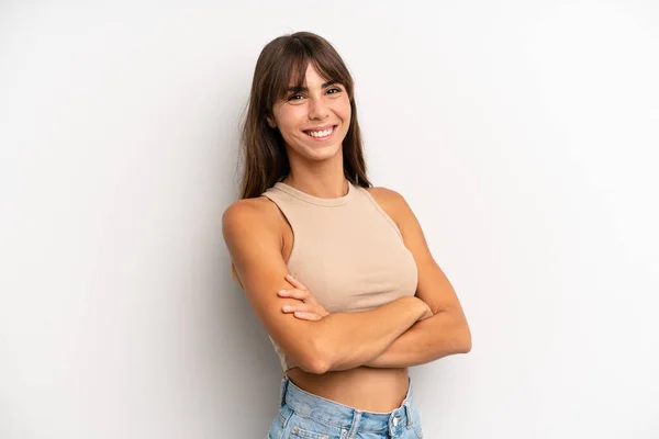 hispanic pretty woman smiling to camera with crossed arms and a happy, confident, satisfied expression, lateral view