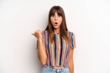 İspanyol asıllı güzel kadın inançsızlıktan şaşkın şaşkın bakıyor, yan taraftaki objeyi işaret ediyor ve diyor ki: