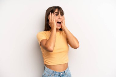 İspanyol güzel kadın mutlu, heyecanlı ve şaşırmış hissediyor, iki eli yüzü yana bakıyor