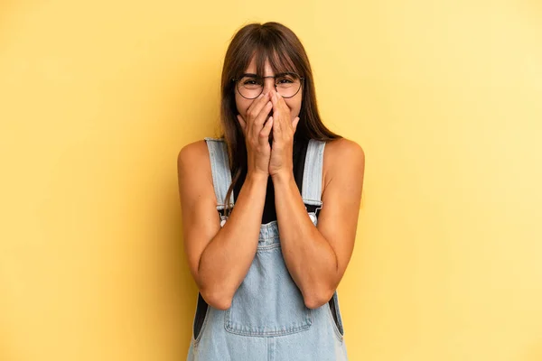 stock image hispanic pretty woman looking happy, cheerful, lucky and surprised covering mouth with both hands