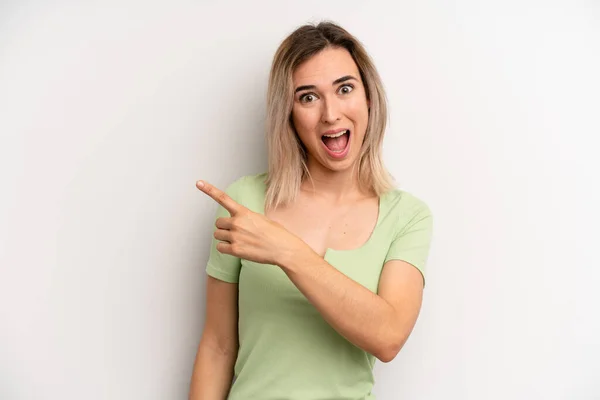 Young Adult Blonde Woman Looking Excited Surprised Pointing Side Upwards — Foto de Stock
