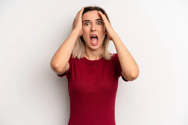 Young Adult Blonde Woman Raising Hands Head Open Mouthed Feeling —  Fotos de Stock