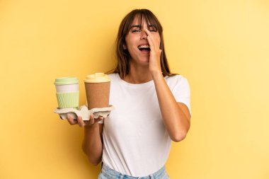 feeling happy,giving a big shout out with hands next to mouth. take away coffees