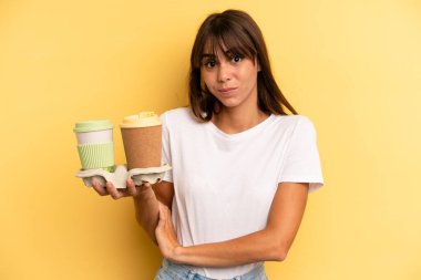shrugging, feeling confused and uncertain. take away coffees