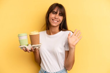 smiling happily, waving hand, welcoming and greeting you. take away coffees