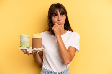 thinking, feeling doubtful and confused. take away coffees