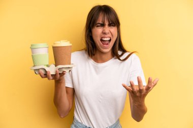 looking angry, annoyed and frustrated. take away coffees