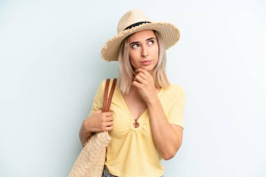 blonde woman thinking, feeling doubtful and confused. summer concept