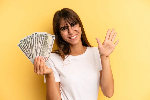 Hispanic Woman Smiling Looking Friendly Showing Number Five Dollar Banknotes — Foto Stock