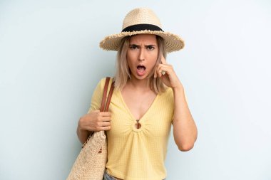 blonde woman looking surprised, realizing a new thought, idea or concept. summer concept