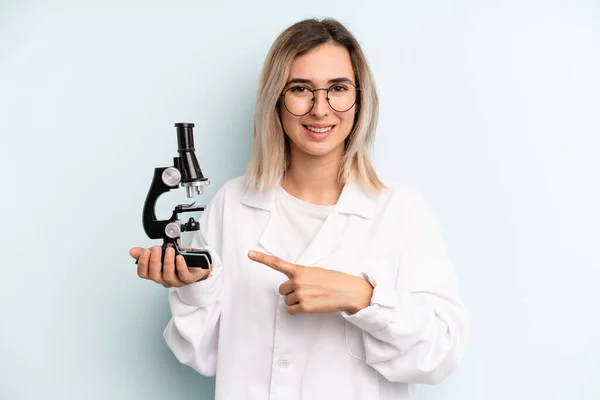 Blonde Woman Smiling Cheerfully Feeling Happy Pointing Side Scientist Student — Stockfoto