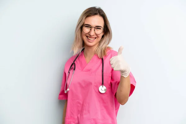 Blonde Woman Feeling Proud Smiling Positively Thumbs Nurse Concept — Zdjęcie stockowe