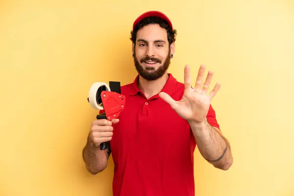 Young Man Smiling Looking Friendly Showing Number Five Company Employee — Stock Photo, Image