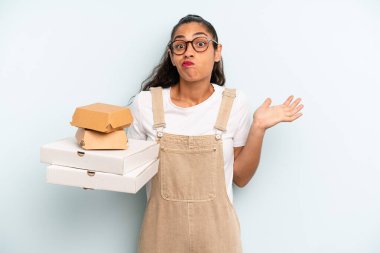 hispanic woman feeling puzzled and confused and doubting. fast food take away concept