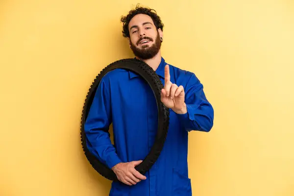 Young Man Smiling Looking Friendly Showing Number One Bike Mechanic — Stock Photo, Image