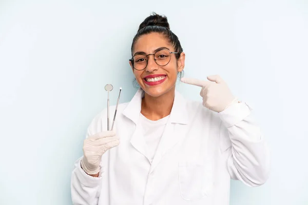 Hispanic Woman Smiling Confidently Pointing Own Broad Smile Dentist Concept — Fotografie, imagine de stoc