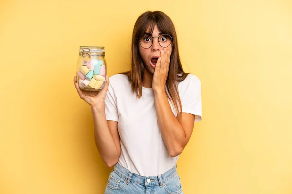 Hispanic Woman Feeling Shocked Scared Candies Bottle Concept — Stok fotoğraf