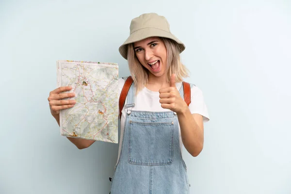 Blonde Woman Feeling Proud Smiling Positively Thumbs Tourist Map Concept — Zdjęcie stockowe