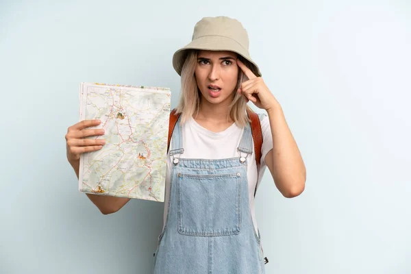Blonde Woman Feeling Confused Puzzled Showing You Insane Tourist Map — Zdjęcie stockowe