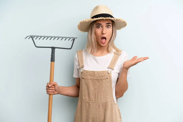 Blonde Woman Looking Surprised Shocked Jaw Dropped Holding Object Farmer — Stockfoto