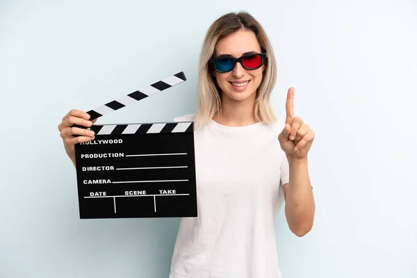 Blonde Woman Smiling Looking Friendly Showing Number One Film Movie — Fotografia de Stock