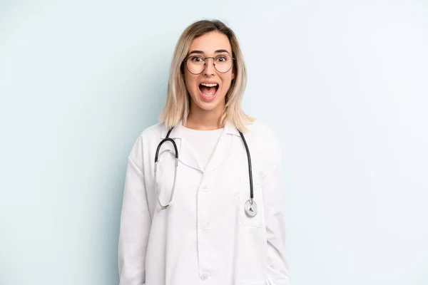 Blonde Woman Looking Happy Pleasantly Surprised Medicine Student Concept — Zdjęcie stockowe