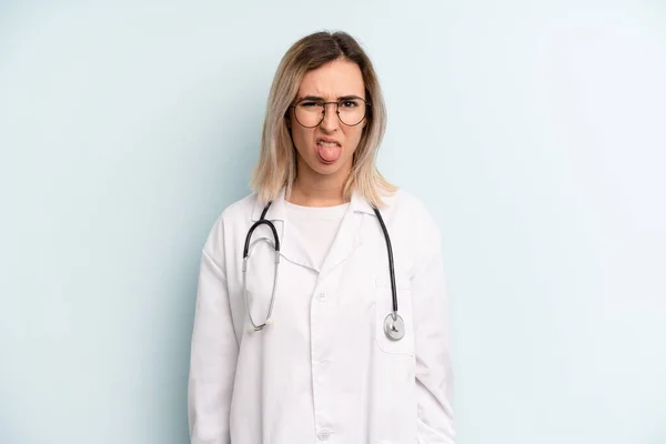 Blonde Woman Feeling Disgusted Irritated Tongue Out Medicine Student Concept — Stockfoto