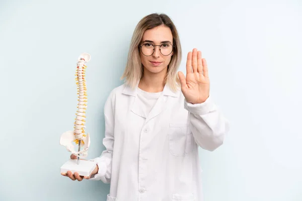 Blonde Woman Looking Serious Showing Open Palm Making Stop Gesture — Stockfoto