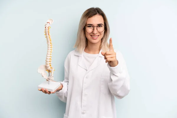 Blonde Woman Smiling Proudly Confidently Making Number One Medicine Student — Stockfoto