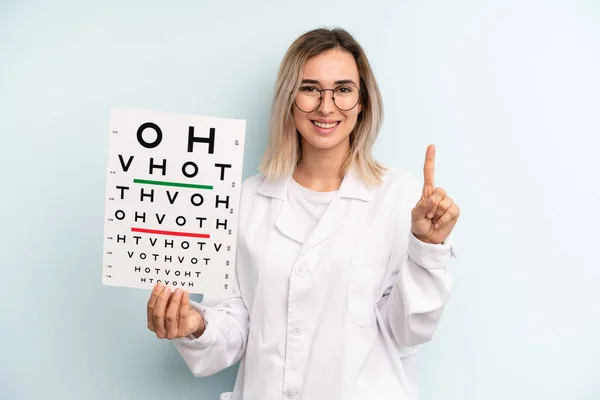 Blonde Woman Smiling Looking Friendly Showing Number One Optical Vision — Stockfoto