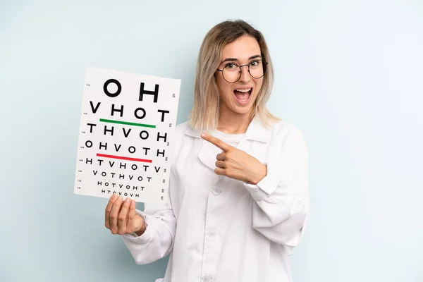 Blonde Woman Looking Excited Surprised Pointing Side Optical Vision Test — Stockfoto