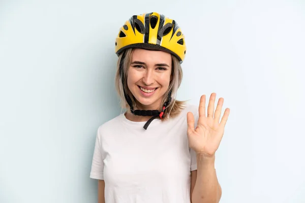 Blonde Woman Smiling Happily Waving Hand Welcoming Greeting You Bike — Zdjęcie stockowe