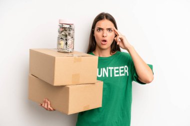 pretty woman looking surprised, realizing a new thought, idea or concept. volunteer and donation concept