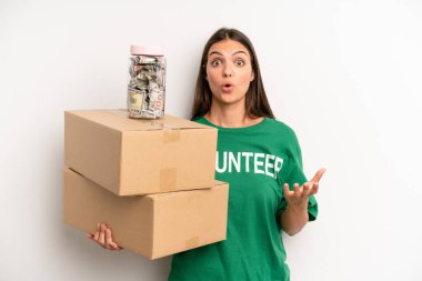 pretty woman feeling extremely shocked and surprised. volunteer and donation concept