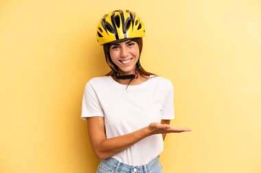 pretty woman smiling cheerfully, feeling happy and showing a concept. bike sport concept