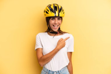 pretty woman looking excited and surprised pointing to the side. bike sport concept